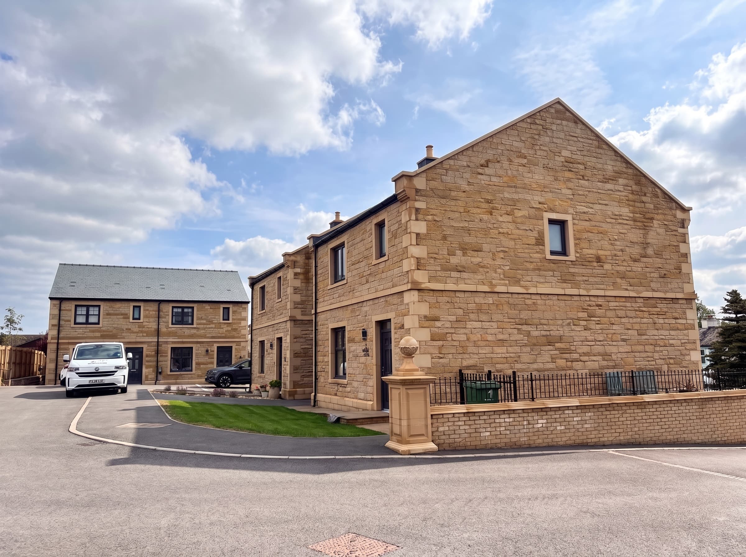 Completed sandstone homes at Swallows Rise around a quiet private road